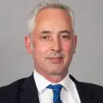 Picture shows a white male wearing a suit, shirt and tie. The man in the image is Rupert Clubb, Lead Officer for Transport for the South East